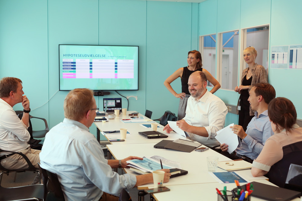 Smiling colleagues working together at a meeting table.